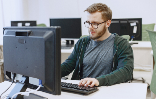 male IT employee of the company works at the computer